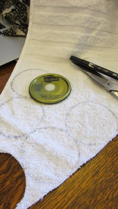 a pair of scissors sitting on top of a white towel