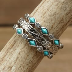 a stack of silver rings with turquoise stones