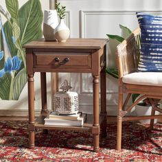 a small wooden table sitting on top of a rug next to a chair and vase