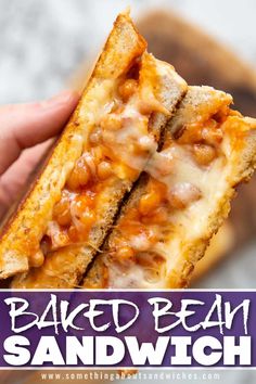 a hand holding up a sandwich with baked beans and cheese on it, in front of the words baked bean sandwich