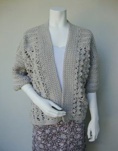 A hand-crocheted kimono style cardigan. This beige cardigan is soft as a cloud, and cozy warm. I designed it for you in the style of the traditional Japanese kimonos. The jacket has a banded front, dropped shoulders, and elbow-length sleeves. Cloverleaf motif lace decorates the hem part of the cardigan. 100% Premium Acrylic.The jacket hangs 24" (61 cm) from shoulders. Women's size M (fits best US size 10-12, UK size 12-14, EU size 38-40). Ready to ship within 24 hrs. The pattern is not for sale. Crochet Kimono Cardigan, White Cotton Cardigan, Beige Kimono, Moda Kimono, Crochet Kimono, Traditional Japanese Kimono, Mode Kimono, Cardigan Kimono, Cardigan Design