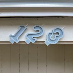 the letters ss and s are cut out on the side of a building's window sill