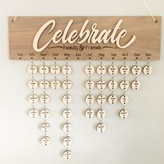 a wooden sign hanging from the side of a wall that says celebrate family and friends