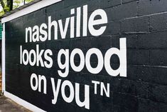 a black and white sign that says nashville looks good on you