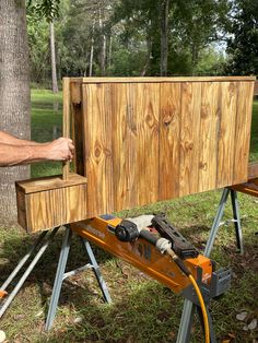 a man is working on a piece of wood with a power drill and an electric screwdriver