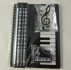 four black and white pencils with musical notes on them in plastic bags next to each other