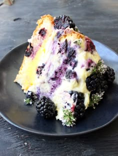 a piece of italian lemon olive oil cake on a plate with berries and blackberries