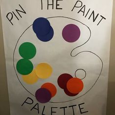 a sign that says pin the paint on it with circles and dots in different colors