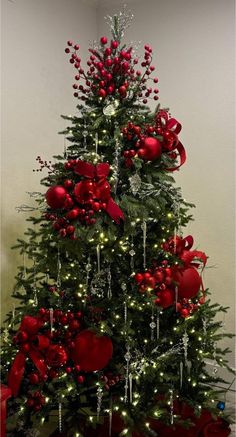 a decorated christmas tree with red ornaments