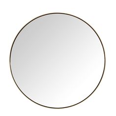 a round mirror sitting on top of a white wall