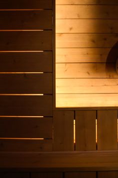 a clock on the side of a wooden wall