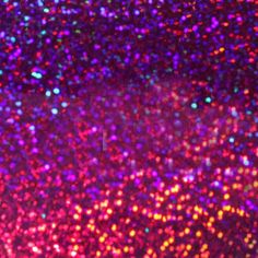 an image of colorful glitter in the air with colors changing from pink to purple and green