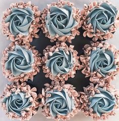 blue and pink cupcakes are arranged in the shape of roses