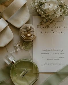 an assortment of personal items are laid out on a table with ribbons and flowers in the background