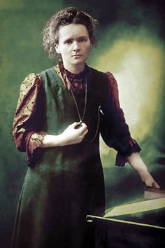 an old photo of a woman standing in front of a table with a box on it