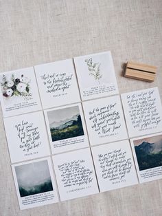 some cards with writing on them sitting next to a rubber stamp and a piece of wood