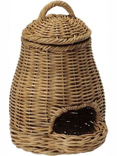 a wicker basket with a black cat in the center and a hole for food inside