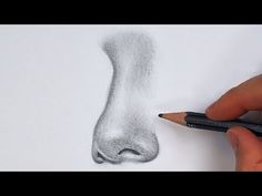 someone is drawing a nose with pencils