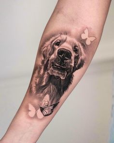 a black and white photo of a dog with butterflies on it's arm is shown