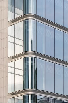 a tall building with lots of windows and a clock on it's front side