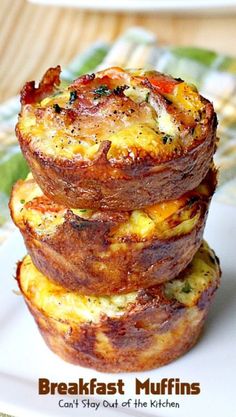 three breakfast muffins stacked on top of each other in front of a plate