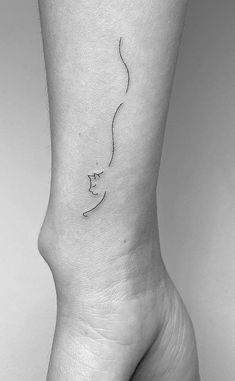 a woman's foot with a small tattoo on the left side of her leg