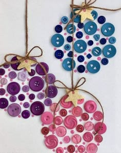 two christmas ornaments made out of buttons and twine