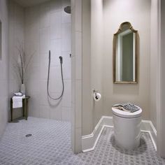 a bathroom with a sink, toilet and shower stall in it's center area