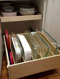 an open drawer with dishes in it