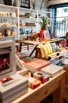 the interior of a store with many items on tables and shelves filled with books, magazines