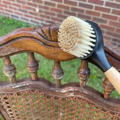 a close up of a brush on a wooden chair