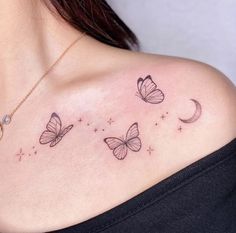 a woman's chest with three butterflies flying over the moon and stars on it