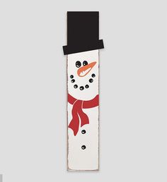 a snowman with a red scarf and black hat on it's head is standing in front of a gray background