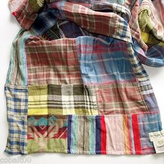 multicolored patchwork shirt laying on top of each other