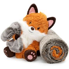 a stuffed animal is sitting next to a rolled up blanket