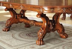 a large wooden table sitting on top of a rug