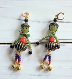 the earrings are decorated with beads and charms