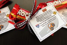 three candy bars wrapped in red and black ribbon