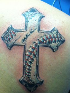 a baseball tattoo on the back of a woman's shoulder with a cross in it