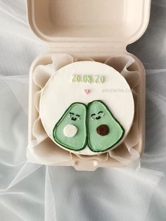 a couple of peas are in a plastic container on a white sheet covered tablecloth