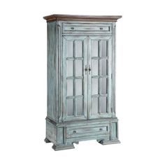 an old blue cabinet with mirrored doors and drawers on the bottom shelf, against a white background