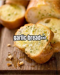 garlic bread on a cutting board with the words garlic bread