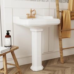 a white sink sitting next to a wooden ladder