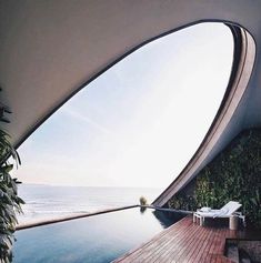 an outdoor swimming pool next to the ocean