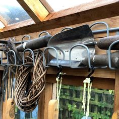 several different types of gardening tools hanging on a wall