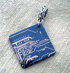 a blue circuit board pendant on a silver chain