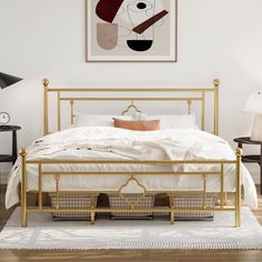 a white bed with gold frame in a bedroom