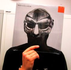 a person pointing at a poster with a helmet on it