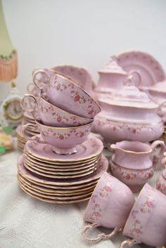 a pile of pink china sitting on top of a table