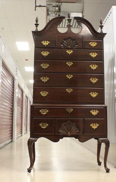 an old dresser is in the middle of a storage room with doors and shutters